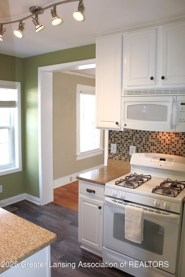 kitchen with white cabinetry, white appliances, and backsplash