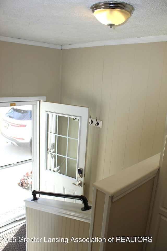 bathroom with a textured ceiling and ornamental molding