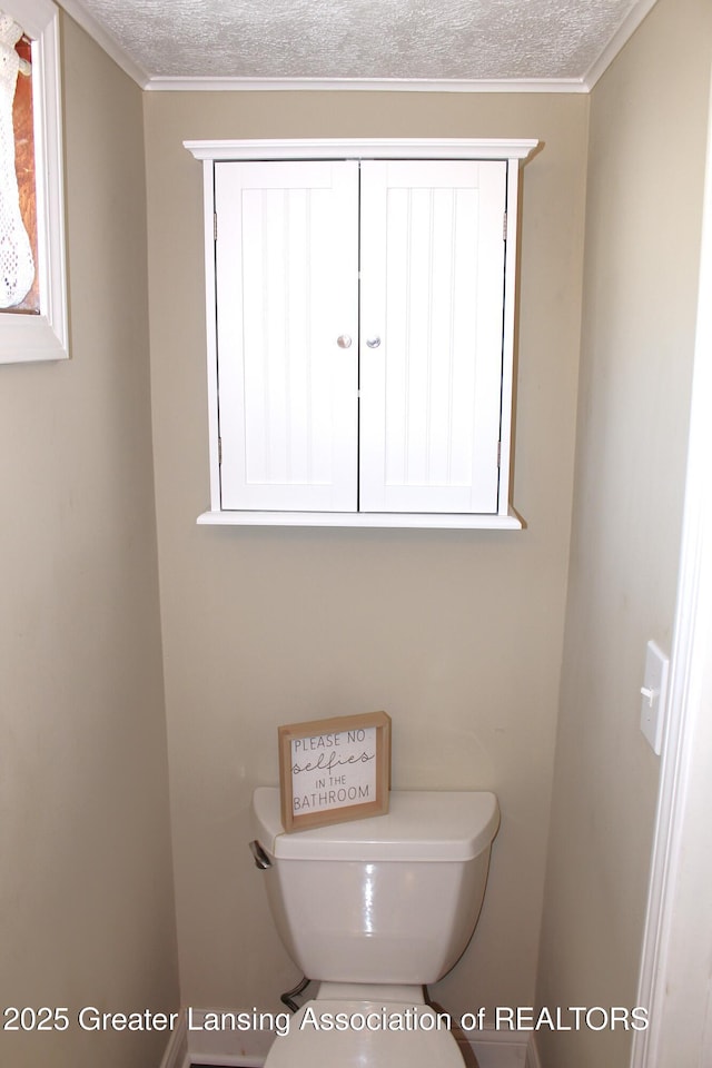 bathroom with toilet and a textured ceiling