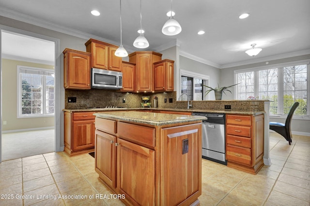 kitchen with decorative backsplash, a center island, a wealth of natural light, and stainless steel appliances