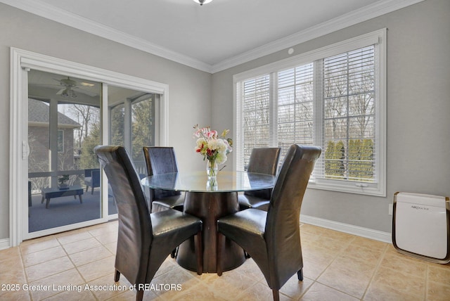 dining room featuring baseboards, plenty of natural light, light tile patterned flooring, and crown molding