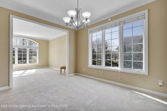 empty room featuring baseboards, crown molding, an inviting chandelier, and carpet floors