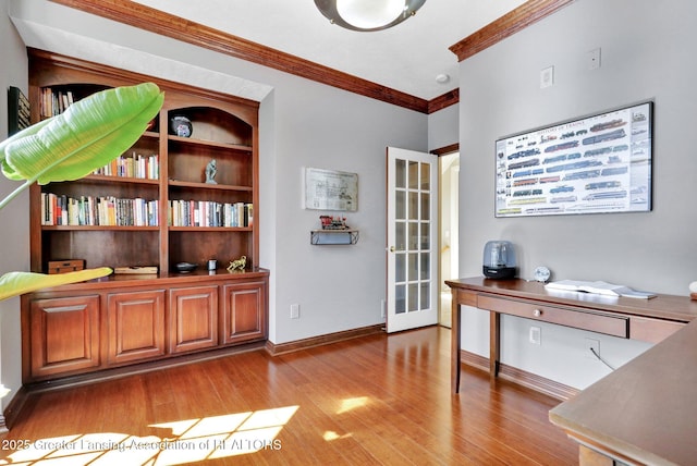 office with baseboards, wood finished floors, and crown molding