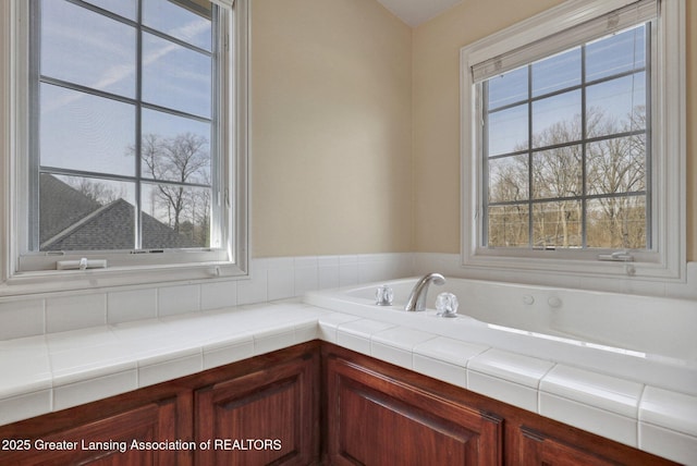 bathroom with a bath and a healthy amount of sunlight