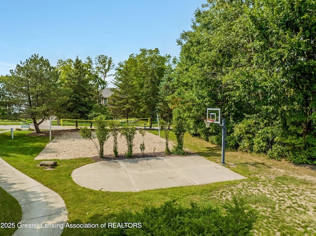 view of sport court featuring volleyball court, community basketball court, and a yard