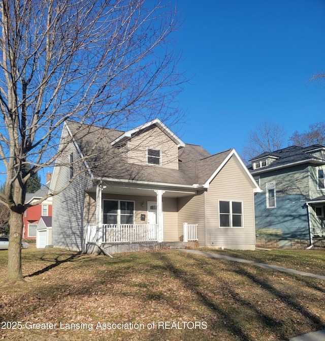 cape cod home with a front yard and covered porch