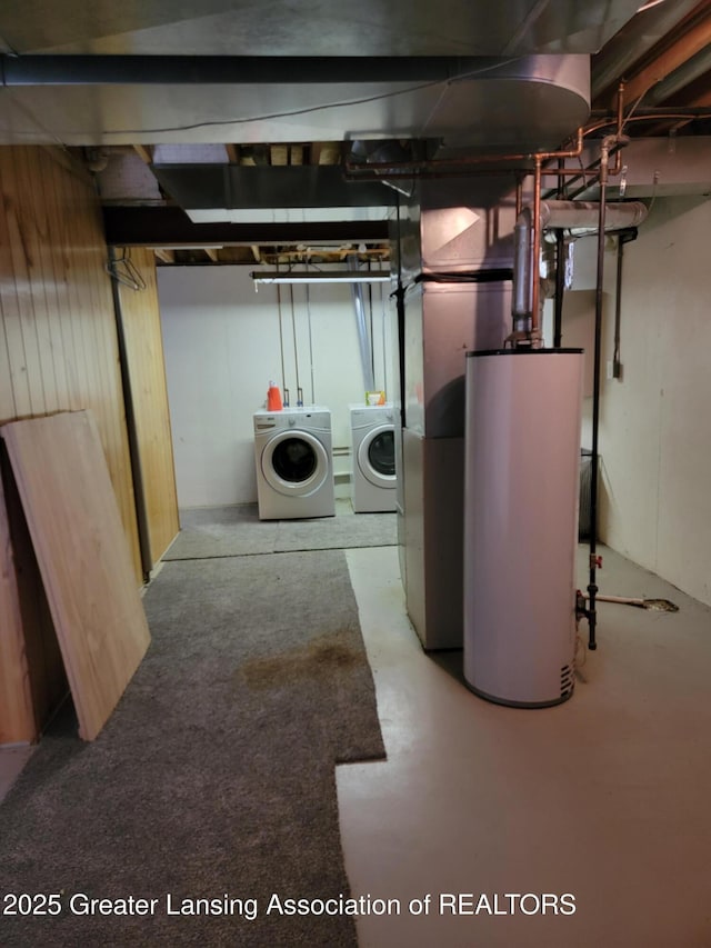 unfinished below grade area with washing machine and dryer and gas water heater