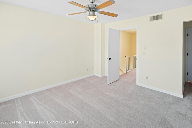 unfurnished bedroom with light colored carpet, baseboards, visible vents, and ceiling fan