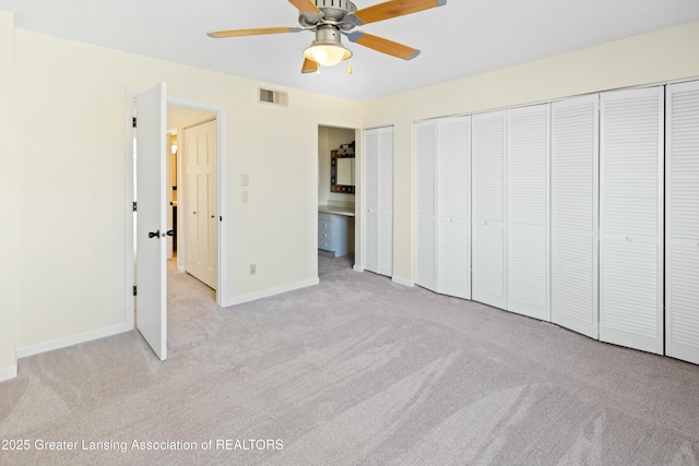 unfurnished bedroom featuring visible vents, light carpet, baseboards, and a ceiling fan