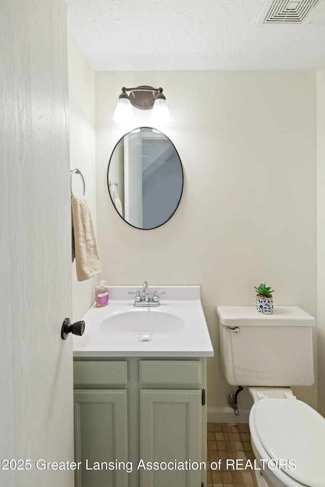 bathroom featuring visible vents, toilet, a textured ceiling, and vanity