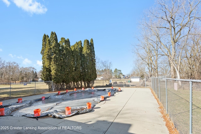 view of parking with fence