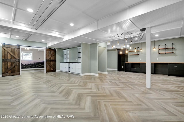 interior space featuring baseboards and a barn door