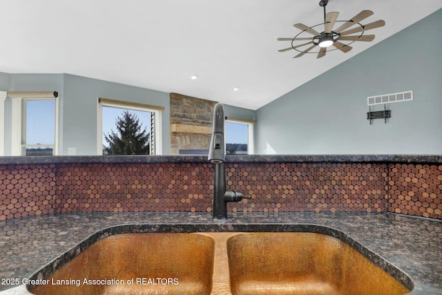 interior details with a sink, visible vents, dark countertops, and a ceiling fan