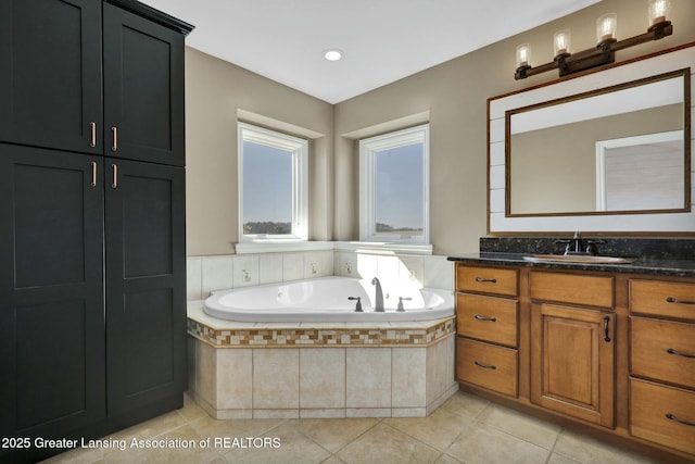 bathroom featuring tile patterned floors, a bath, and vanity