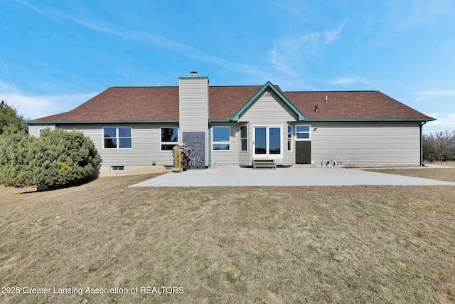 back of property featuring entry steps, a patio area, a lawn, and a chimney