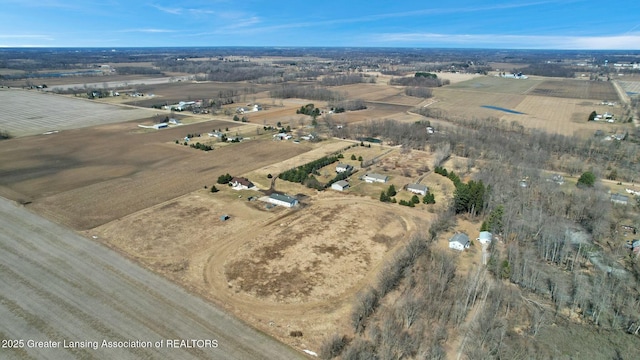 birds eye view of property with a rural view