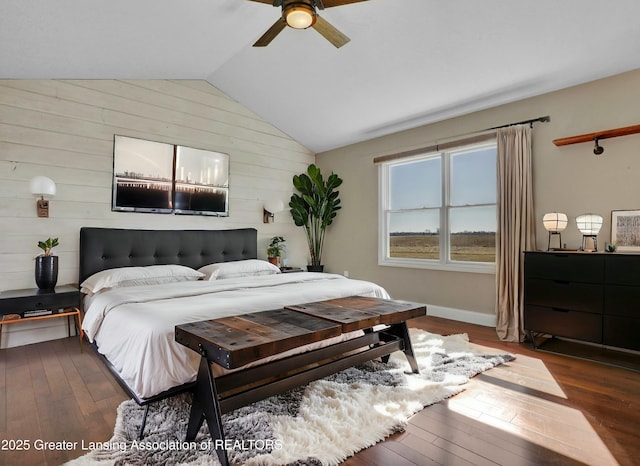 bedroom with dark wood finished floors, lofted ceiling, a ceiling fan, and baseboards