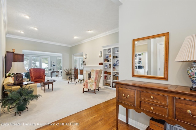 living area with wood finished floors, recessed lighting, and ornamental molding