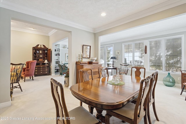 dining room with baseboards, recessed lighting, a textured ceiling, crown molding, and light colored carpet