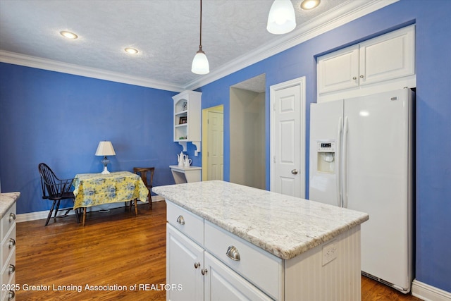 kitchen featuring white cabinetry, crown molding, and white fridge with ice dispenser