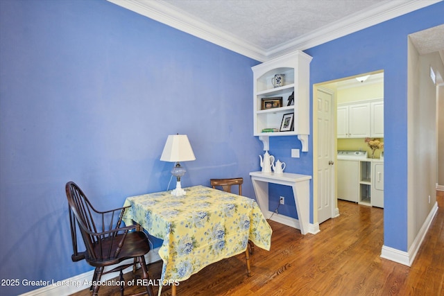 bedroom with washer and dryer, baseboards, wood finished floors, and ornamental molding