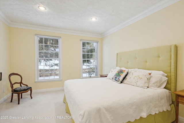 bedroom with a textured ceiling, light colored carpet, baseboards, and ornamental molding