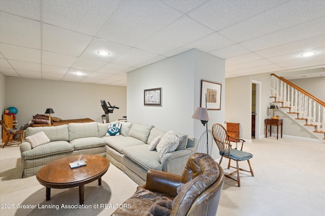 living area featuring stairway, recessed lighting, carpet, and a drop ceiling