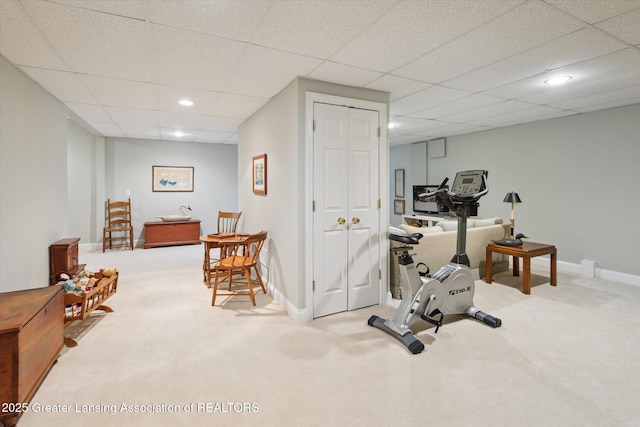 exercise area featuring recessed lighting, carpet, baseboards, and a drop ceiling