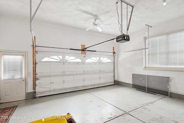 garage with a garage door opener and baseboards