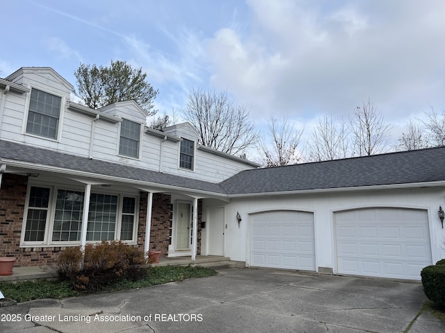 view of front of house with an attached garage, brick siding, driveway, and roof with shingles