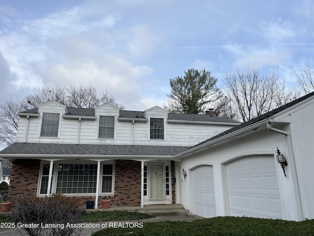 traditional home with brick siding, a shingled roof, covered porch, a chimney, and a garage