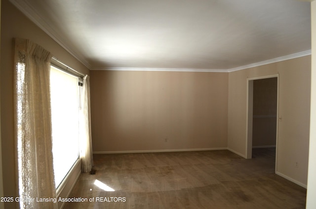 empty room with baseboards and crown molding