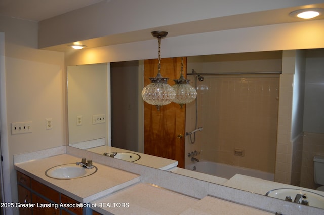 bathroom with shower / bathing tub combination, toilet, and vanity