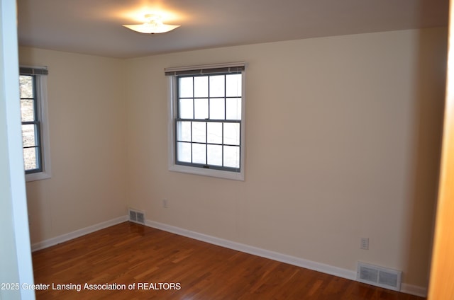 unfurnished room with visible vents, plenty of natural light, and baseboards