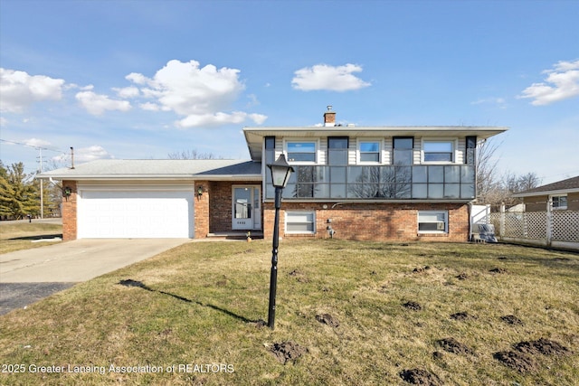 split level home featuring fence, driveway, a front lawn, a garage, and brick siding