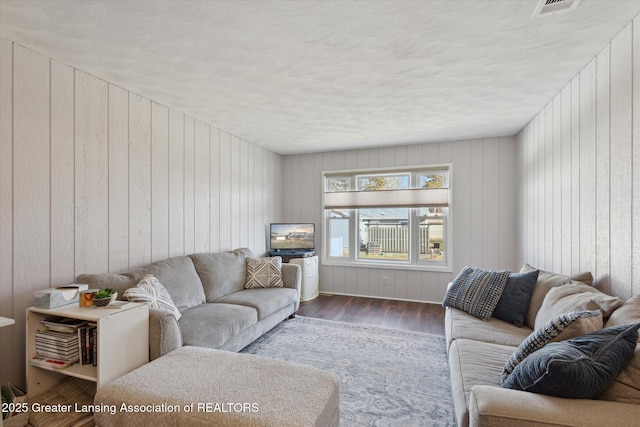 living area featuring wood finished floors and a textured ceiling