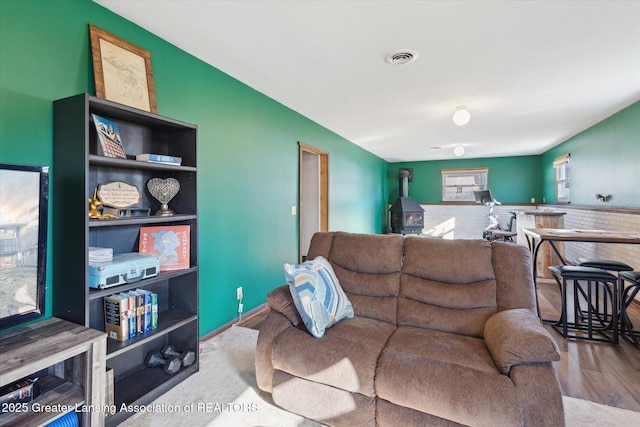 living area featuring wood finished floors and visible vents