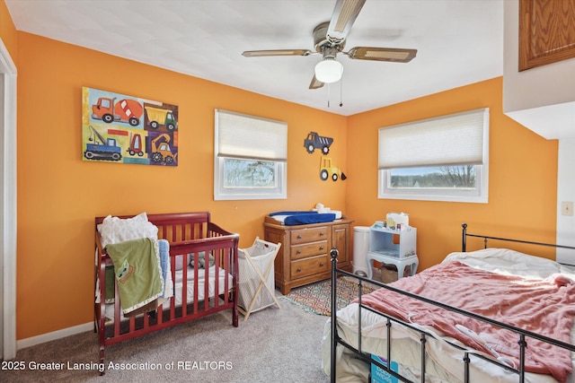 bedroom featuring baseboards, ceiling fan, and carpet flooring