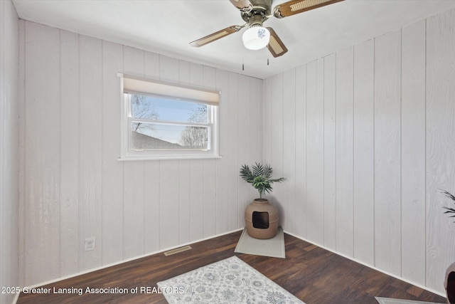 interior space featuring visible vents, a ceiling fan, and wood finished floors