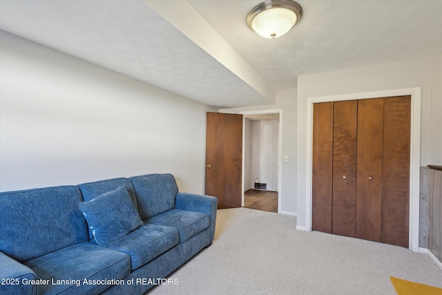 living room with baseboards and carpet