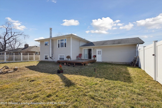 rear view of house featuring a yard, a fenced backyard, and a wooden deck