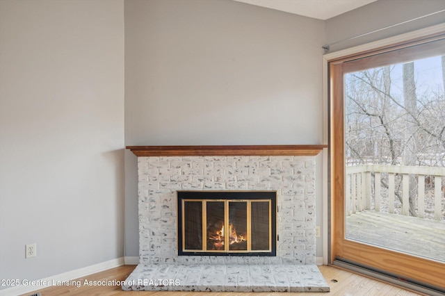 details with wood finished floors, a fireplace, and baseboards