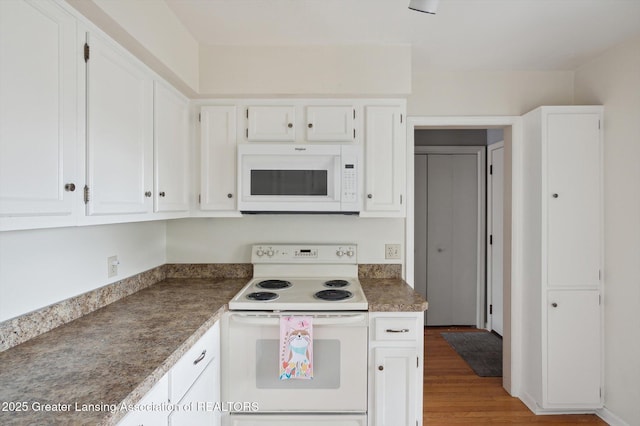 kitchen featuring white cabinetry, white appliances, and wood finished floors