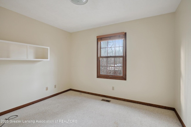 unfurnished room with visible vents, baseboards, and carpet