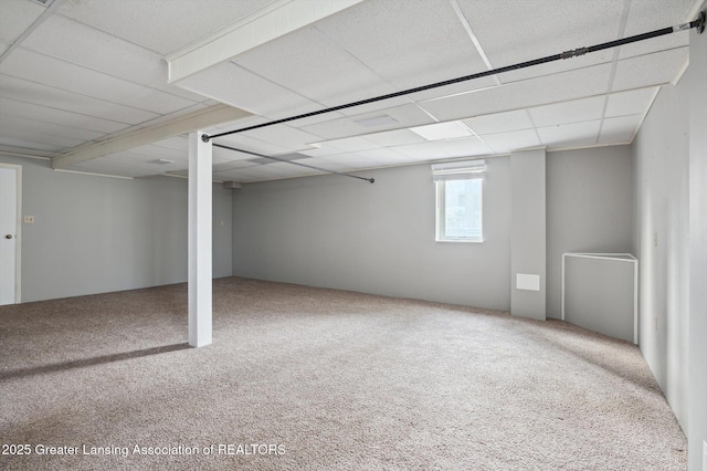 below grade area featuring a drop ceiling and carpet floors