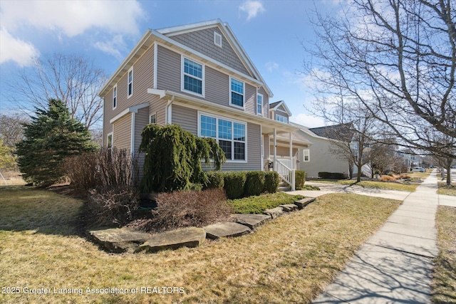 view of home's exterior featuring a yard and covered porch