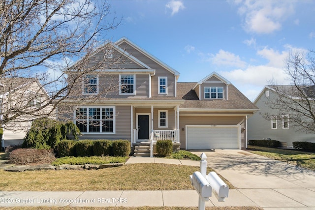 view of front facade with a porch, an attached garage, driveway, and a front yard