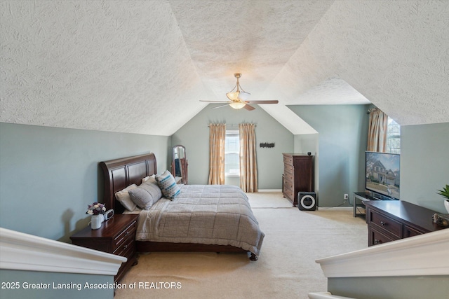 bedroom featuring a ceiling fan, baseboards, carpet floors, lofted ceiling, and a textured ceiling