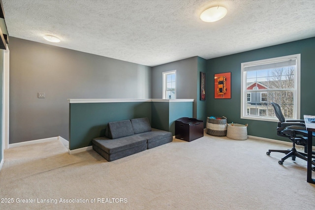 carpeted office with plenty of natural light, baseboards, and a textured ceiling