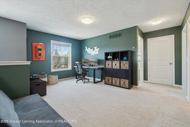 office with visible vents, baseboards, carpet, and a textured ceiling